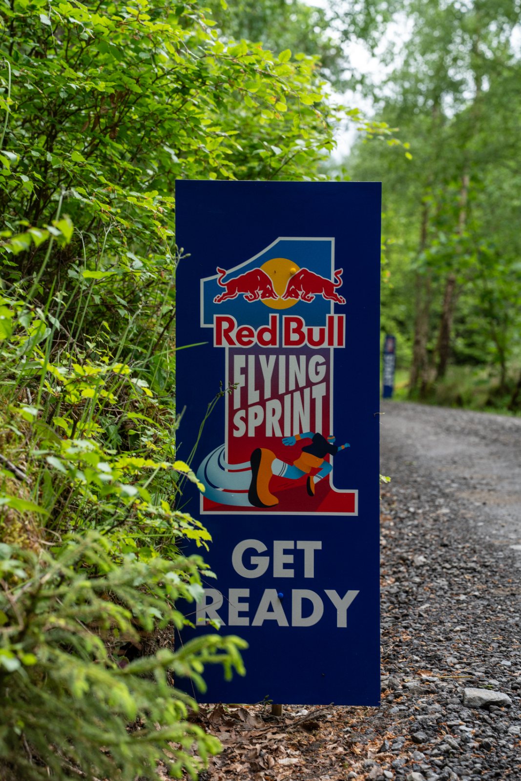 Rider with a Red Bull can at the roadside